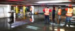 Construction crew working in flooded parking garage