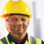 construction worker with a smile on his face with a sad face overlay