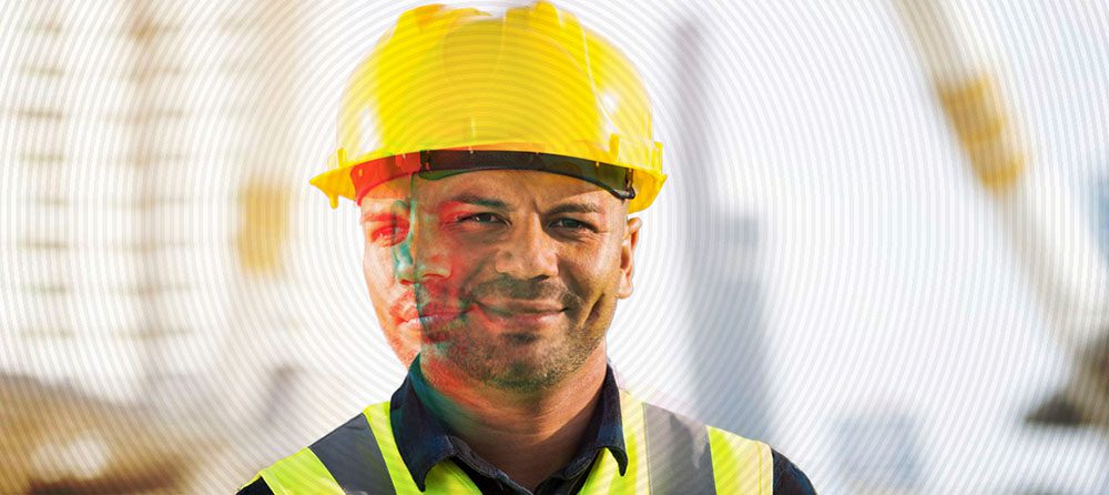 construction worker with a smile on his face with a sad face overlay